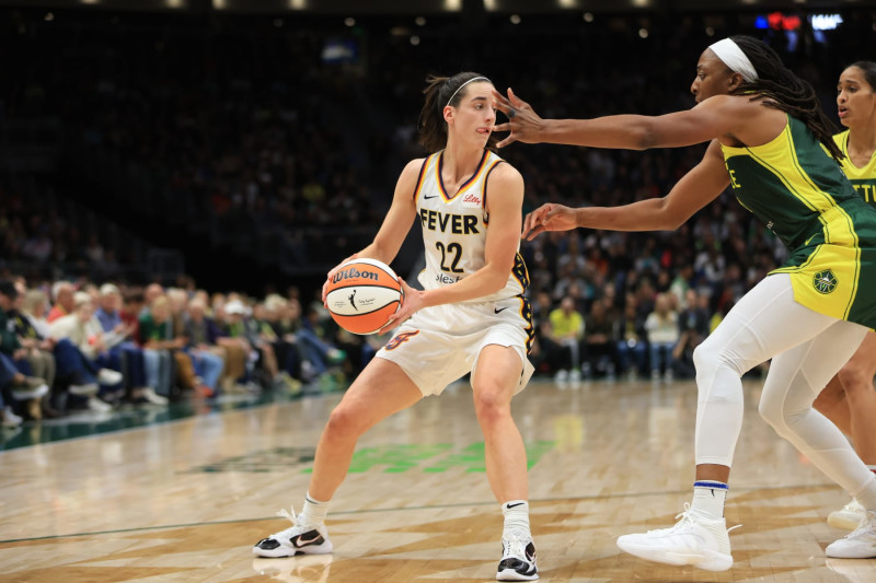 SEATTLE, WA - MAY 22: Caitlin Clark #22 of the Indiana Fever handles the ball during the game against the Seattle Storm on May 22, 2024 at Climate Pledge Arena in Seattle, Washington. NOTE TO USER: User expressly acknowledges and agrees that, by downloading and or using this photograph, User is consenting to the terms and conditions of the Getty Images License Agreement. Mandatory Copyright Notice: Copyright 2024 NBAE (Photo by Scott Eklund/NBAE via Getty Images)