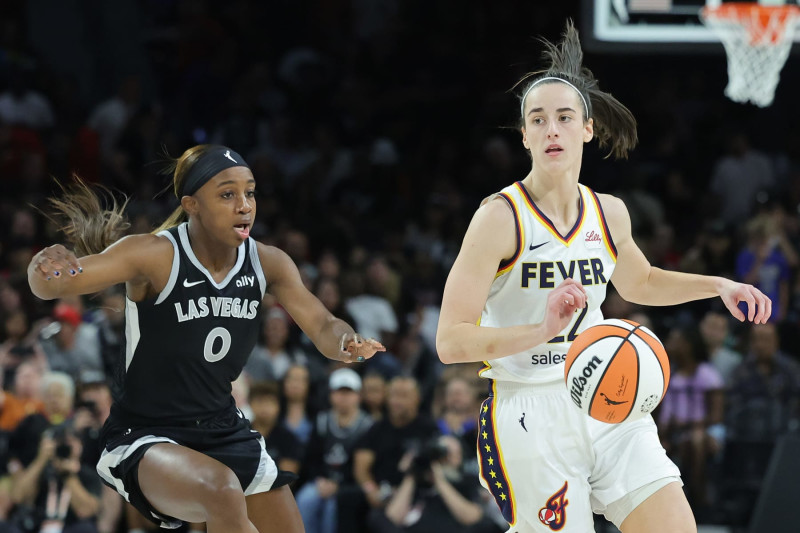 LAS VEGAS, NEVADA - MAY 25: Caitlin Clark #22 of the Indiana Fever dribbles against Jackie Young #0 of the Las Vegas Aces during the first quarter in the game at Michelob ULTRA Arena on May 25, 2024 in Las Vegas, Nevada. NOTE TO USER: User expressly acknowledges and agrees that, by downloading and or using this photograph, User is consenting to the terms and conditions of the Getty Images License Agreement. (Photo by Ethan Miller/Getty Images)