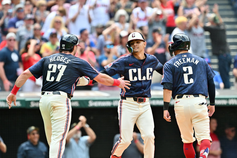 CLEVELAND, OHIO - MAY 22: Austin Hedges #27, Andrés Giménez #0, and Tyler Freeman #2 of the Cleveland Guardians celebrate after all scored on a homer by Giménez during the sixth inning against the New York Mets at Progressive Field on May 22, 2024 in Cleveland, Ohio. (Photo by Jason Miller/Getty Images)