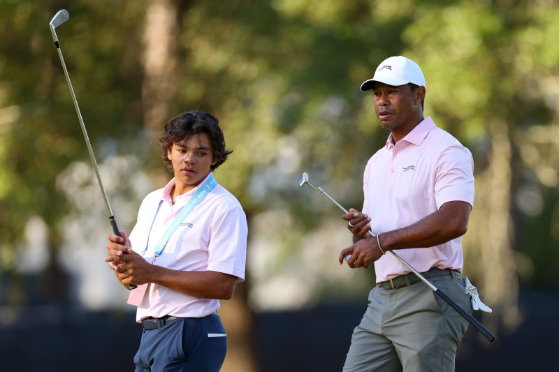 PINEHURST, NORTH CAROLINA - JUNE 11: Tiger Woods of the United States and his son, Charlie Woods, look on from the second hole during a practice round prior to the U.S. Open at Pinehurst Resort on June 11, 2024 in Pinehurst, North Carolina. (Photo by Andrew Redington/Getty Images)