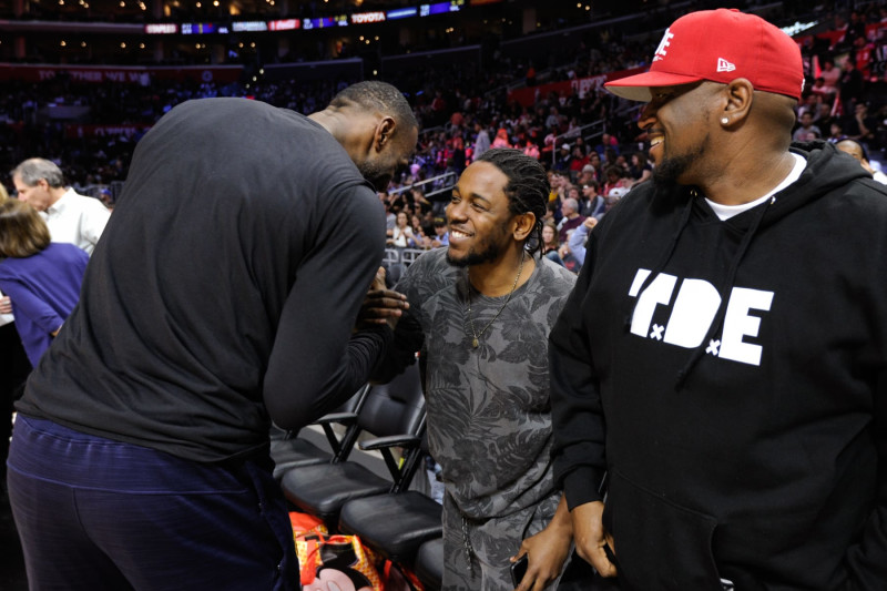 LOS ANGELES, CA - MARCH 13:  Kendrick Lamar (C) greets LeBron James at a basketball game between the Cleveland Cavaliers and the Los Angeles Clippers at Staples Center on March 13, 2016 in Los Angeles, California.  (Photo by Noel Vasquez/GC Images)