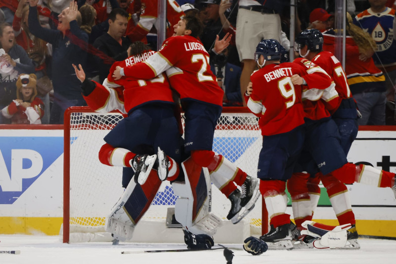 SUNRISE, FLORIDA - JUNE 24: Sergei Bobrovsky #72, Sam Reinhart #13, and Eetu Luostarinen #27 of the Florida Panthers celebrate after their 2-1 victory against the Edmonton Oilers in Game Seven of the 2024 Stanley Cup Final at Amerant Bank Arena on June 24, 2024 in Sunrise, Florida. (Photo by Bruce Bennett/Getty Images)