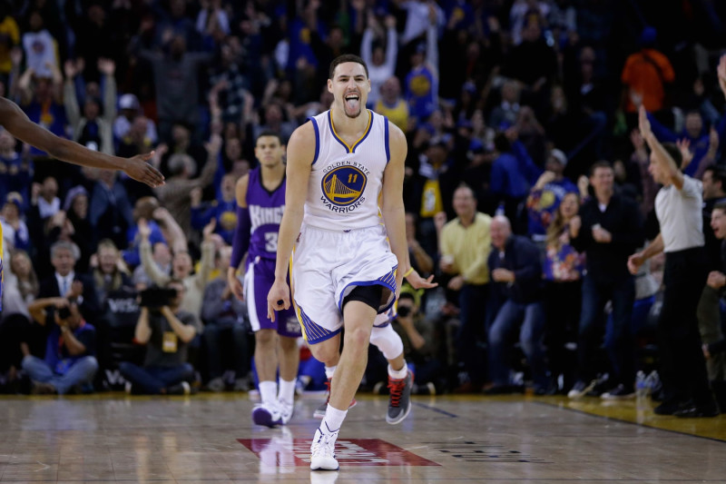 OAKLAND, CA - JANUARY 23:  Klay Thompson #11 of the Golden State Warriors reacts after he made a three-point basket in the third quarter of their game against the Sacramento Kings at ORACLE Arena on January 23, 2015 in Oakland, California. Thompson scored 37 points in the third quarter to set a NBA record. NOTE TO USER: User expressly acknowledges and agrees that, by downloading and or using this photograph, User is consenting to the terms and conditions of the Getty Images License Agreement.  (Photo by Ezra Shaw/Getty Images)