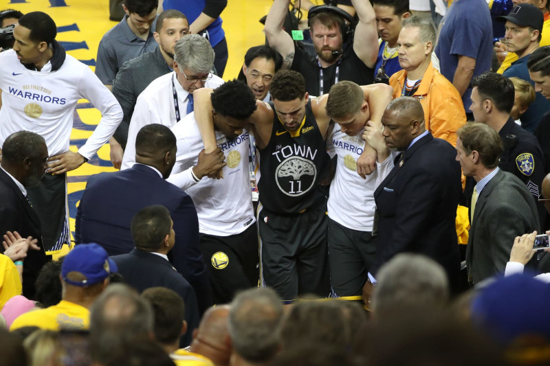 OAKLAND, CA - JUNE 13: Klay Thompson #11 of the Golden State Warriors is assisted off court after injuring his knee against the Toronto Raptors during Game Six of the NBA Finals on June 13, 2019 at ORACLE Arena in Oakland, California. NOTE TO USER: User expressly acknowledges and agrees that, by downloading and/or using this photograph, user is consenting to the terms and conditions of Getty Images License Agreement. Mandatory Copyright Notice: Copyright 2019 NBAE (Photo by Joe Murphy/NBAE via Getty Images)