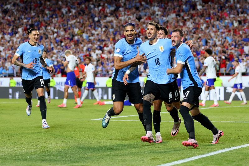 KANSAS CITY, MISSOURI - JULY 01: Mathias Olivera of Uruguay  celebrates  with teammates after scoring the team's first goal during the CONMEBOL Copa America 2024 Group C match between United States and Uruguay at GEHA Field at Arrowhead Stadium on July 01, 2024 in Kansas City, Missouri. (Photo by Michael Reaves/Getty Images)