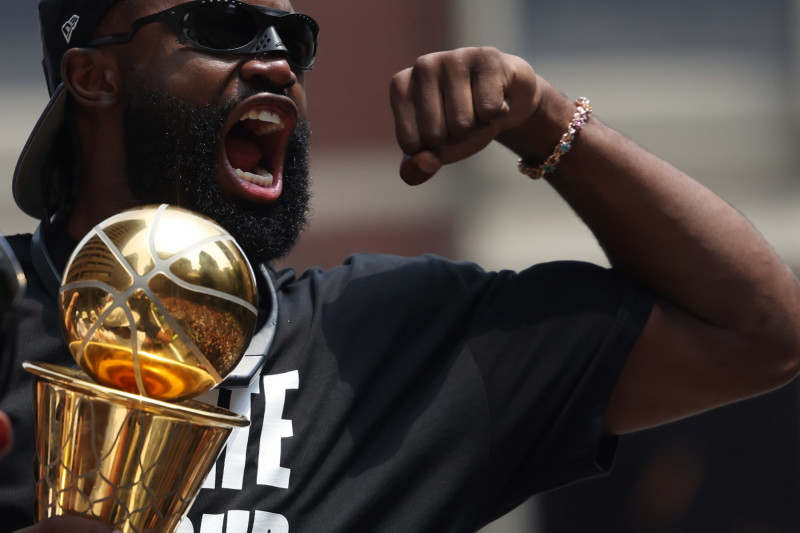 Boston, MA - June 21: Boston Celtics SG Jaylen Brown holds the trophy during a duck boat parade to celebrate the 18th Boston Celtics NBA championship. (Photo by Jessica Rinaldi/The Boston Globe via Getty Images)