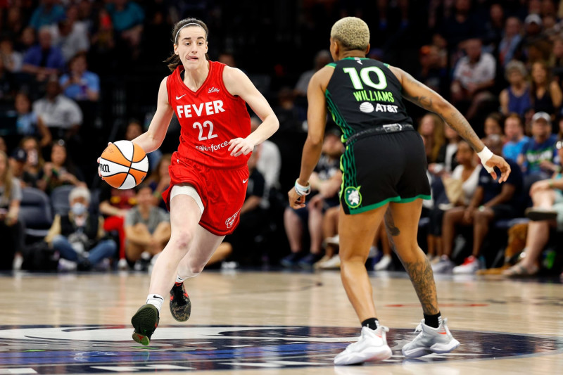 MINNEAPOLIS, MINNESOTA - JULY 14: Caitlin Clark #22 of the Indiana Fever dribbles the ball against Courtney Williams #10 of the Minnesota Lynx in the first quarter at Target Center on July 14, 2024 in Minneapolis, Minnesota. NOTE TO USER: User expressly acknowledges and agrees that, by downloading and or using this photograph, User is consenting to the terms and conditions of the Getty Images License Agreement. (Photo by David Berding/Getty Images)