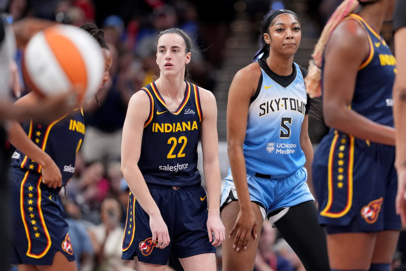 INDIANAPOLIS, INDIANA - JUNE 16: Caitlin Clark #22 of the Indiana Fever and Angel Reese #5 of the Chicago Sky look on during a game at Gainbridge Fieldhouse on June 16, 2024 in Indianapolis, Indiana. NOTE TO USER: User expressly acknowledges and agrees that, by downloading and or using this photograph, User is consenting to the terms and conditions of the Getty Images License Agreement. (Photo by Emilee Chinn/Getty Images)