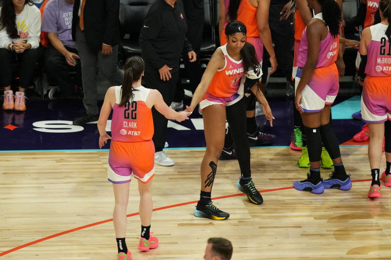 PHOENIX, AZ - JULY 20: Caitlin Clark #22 and Angel Reese #5 of Team WNBA high five during the game against the USA Basketball Women's National Team during the 2024 WNBA All Star Game on July 20, 2024 at Footprint Center in Phoenix, Arizona. NOTE TO USER: User expressly acknowledges and agrees that, by downloading and or using this photograph, user is consenting to the terms and conditions of the Getty Images License Agreement. Mandatory Copyright Notice: Copyright 2024 NBAE (Photo by Catalina Fragoso/NBAE via Getty Images)