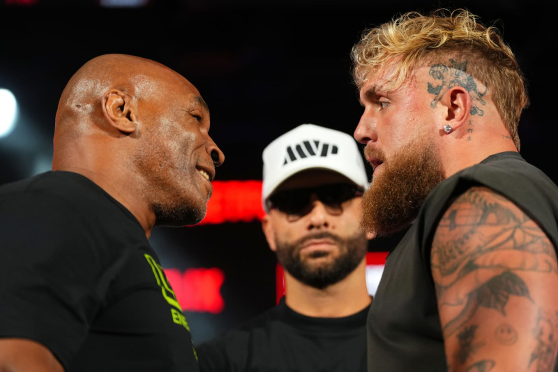 ARLINGTON, TEXAS - MAY 16: (L-R) Mike Tyson, Nakisa Bidarian and Jake Paul pose onstage during the Jake Paul vs. Mike Tyson Boxing match Arlington press conference at Texas Live! on May 16, 2024 in Arlington, Texas.  (Photo by Cooper Neill/Getty Images for Netflix)