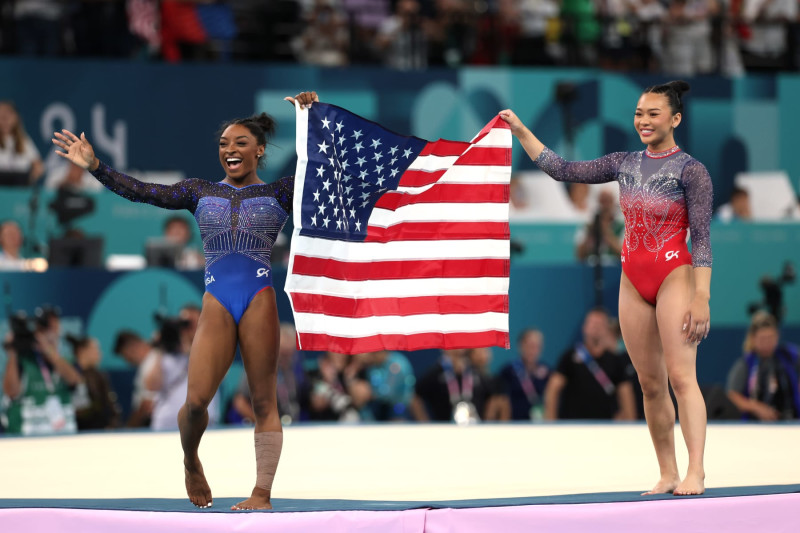 PARIS, FRANCE - AUGUST 01: (L-R) Gold medalist Simone Biles and Bronze medalist Sunisa Lee of Team United States celebrate after competing in the Artistic Gymnastics Women's All-Around Final on day six of the Olympic Games Paris 2024 at Bercy Arena on August 01, 2024 in Paris, France. (Photo by Ezra Shaw/Getty Images)