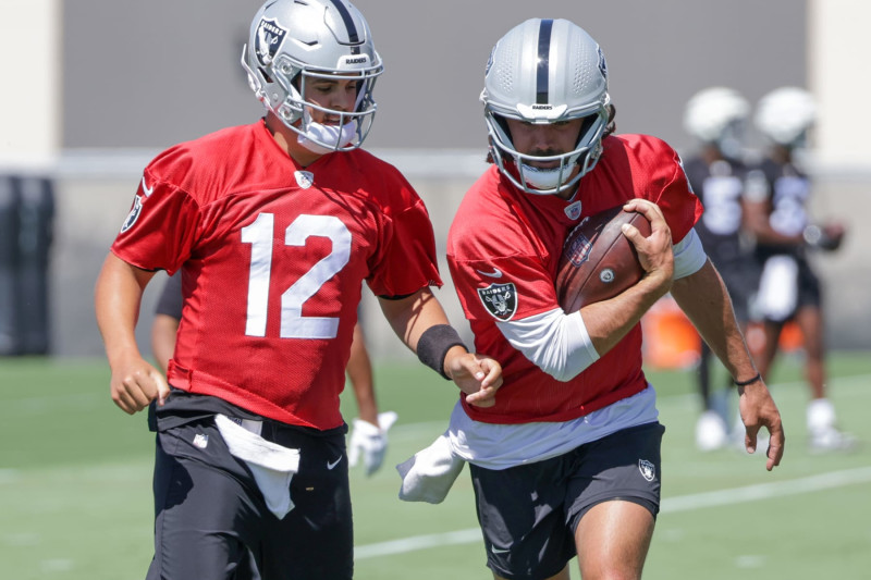 HENDERSON, NEVADA - MAY 29: Quarterbacks Aidan O'Connell #12 and Gardner Minshew #15 of the Las Vegas Raiders run through a drill during an OTA offseason workout at the Las Vegas Raiders Headquarters/Intermountain Healthcare Performance Center on May 29, 2024 in Henderson, Nevada. (Photo by Ethan Miller/Getty Images)