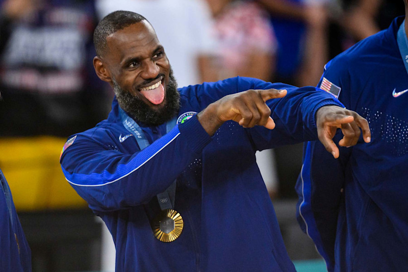 PARIS, FRANCE - AUGUST 11: Gold medalist LeBron James of Team United States celebrate on the podium during the Men's basketball medal ceremony on day fifteen of the Olympic Games Paris 2024 at the Bercy Arena on August 11, 2024 in Paris, France. (Photo by Tom Weller/VOIGT/GettyImages)