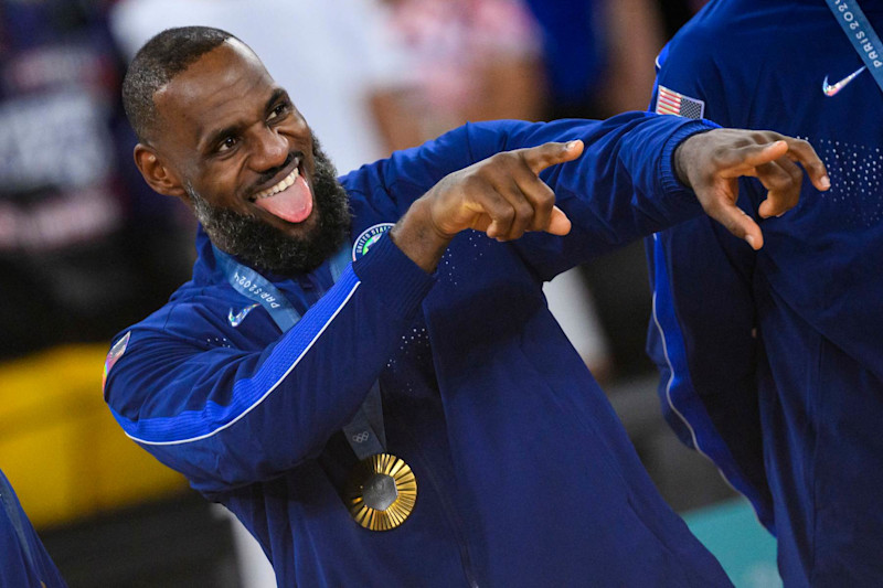 PARIS, FRANCE - AUGUST 11: Gold medalist LeBron James of Team United States celebrate on the podium during the Men's basketball medal ceremony on day fifteen of the Olympic Games Paris 2024 at the Bercy Arena on August 11, 2024 in Paris, France. (Photo by Tom Weller/VOIGT/GettyImages)