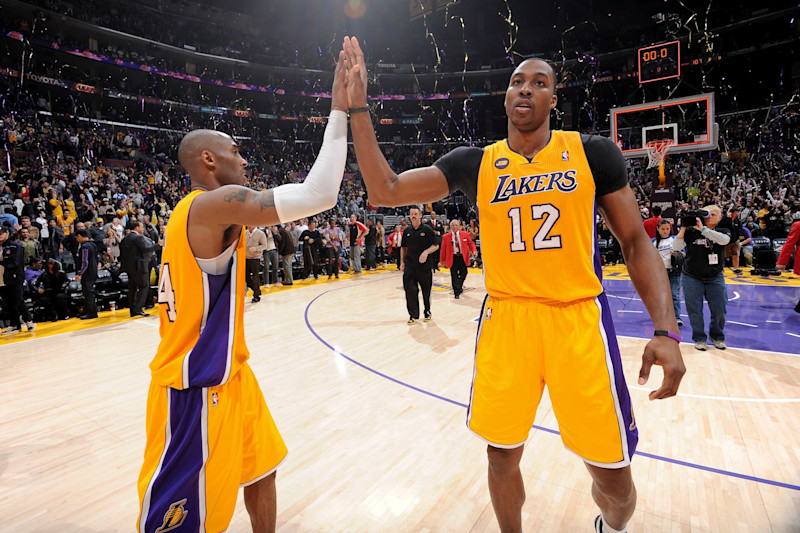 LOS ANGELES, CA - FEBRUARY 22: Kobe Bryant #24 and Dwight Howard #12 of the Los Angeles Lakers celebrate after their team's victory against the Portland Trail Blazers at Staples Center on February 22, 2013 in Los Angeles, California. NOTE TO USER: User expressly acknowledges and agrees that, by downloading and/or using this Photograph, user is consenting to the terms and conditions of the Getty Images License Agreement. Mandatory Copyright Notice: Copyright 2013 NBAE (Photo by Andrew D. Bernstein/NBAE via Getty Images)