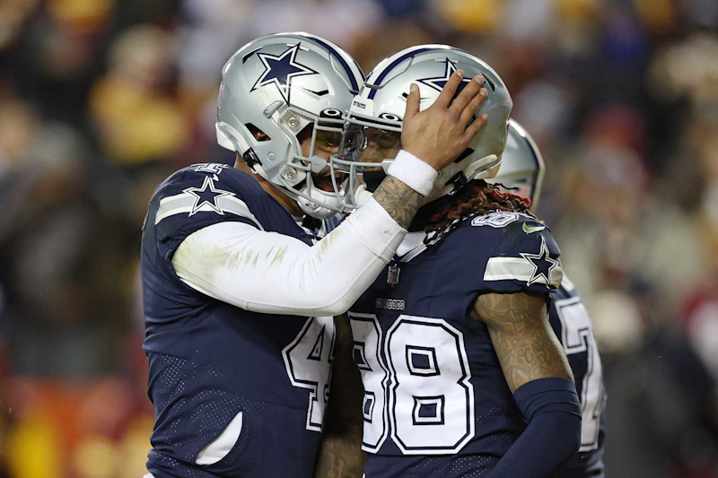 LANDOVER, MARYLAND - JANUARY 08: CeeDee Lamb #88 of the Dallas Cowboys celebrates a touchdown with Dak Prescott #4 of the Dallas Cowboys during the second quarter of the game against the Washington Commanders at FedExField on January 08, 2023 in Landover, Maryland. (Photo by Rob Carr/Getty Images)