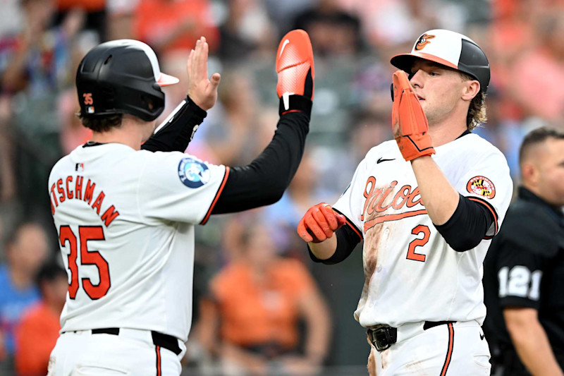 BALTIMORE, MARYLAND - JULY 30: Adley Rutschman #35 and Gunnar Henderson #2 of the Baltimore Orioles celebrate scoring in the third inning against the Toronto Blue Jays at Oriole Park at Camden Yards on July 30, 2024 in Baltimore, Maryland. (Photo by Greg Fiume/Getty Images)