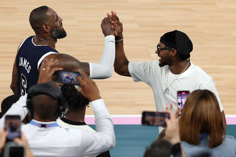 PARIS, FRANCE - AUGUST 10: LeBron James #6 of Team United States high fives his son and NBA player Bronny James after Team United States' victory against Team France during the Men's Gold Medal game between Team France and Team United States on day fifteen of the Olympic Games Paris 2024 at Bercy Arena on August 10, 2024 in Paris, France. (Photo by Jamie Squire/Getty Images)