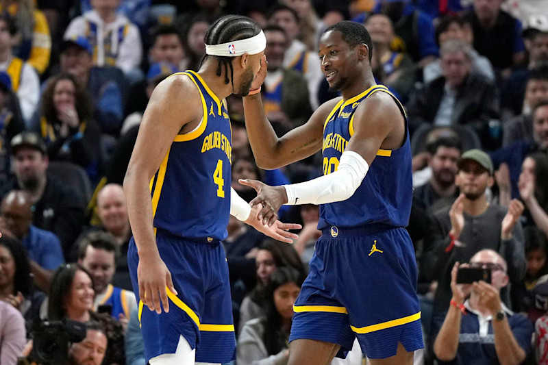 SAN FRANCISCO, CALIFORNIA - APRIL 07: Jonathan Kuminga #00 of the Golden State Warriors is congratulated by Moses Moody #4 after Kuminga scored and was fouled on the shot against the Utah Jazz during second half at Chase Center on April 07, 2024 in San Francisco, California. NOTE TO USER: User expressly acknowledges and agrees that, by downloading and or using this photograph, User is consenting to the terms and conditions of the Getty Images License Agreement. (Photo by Thearon W. Henderson/Getty Images)