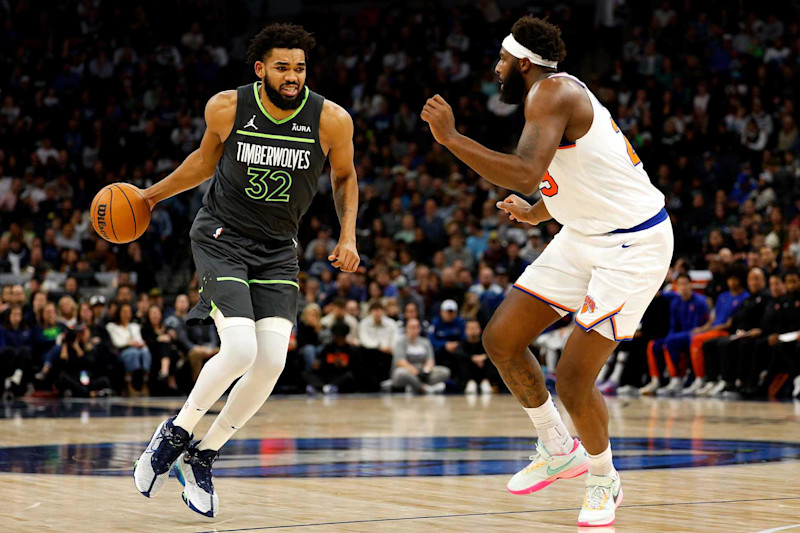 MINNEAPOLIS, MINNESOTA - NOVEMBER 20: Karl-Anthony Towns #32 of the Minnesota Timberwolves drives to the basket while Mitchell Robinson #23 of the New York Knicks defends in the second quarter at Target Center on November 20, 2023 in Minneapolis, Minnesota. The Timberwolves defeated the Knicks 117-100. NOTE TO USER: User expressly acknowledges and agrees that, by downloading and or using this photograph, User is consenting to the terms and conditions of the Getty Images License Agreement. (Photo by David Berding/Getty Images)