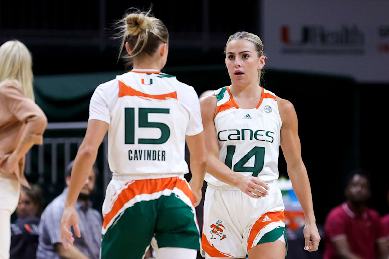 CORAL GABLES, FLORIDA - FEBRUARY 09: Hanna Cavinder #15 and Haley Cavinder #14 of the Miami Hurricanes talk on the court during the second quarter of the game against the Florida State Seminoles at Watsco Center on February 09, 2023 in Coral Gables, Florida. (Photo by Megan Briggs/Getty Images)