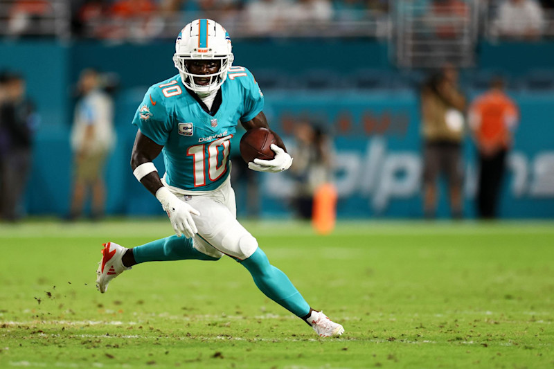 MIAMI GARDENS, FL - SEPTEMBER 30: Tyreek Hill #10 of the Miami Dolphins carries the ball during the second quarter against the Tennessee Titans at Hard Rock Stadium on September 30, 2024 in Miami Gardens, Florida. (Photo by Kevin Sabitus/Getty Images)