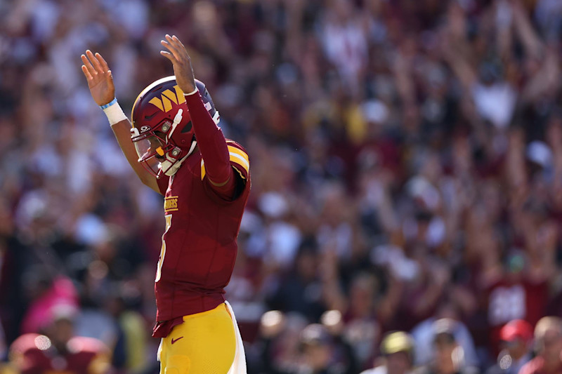 LANDOVER, MARYLAND - OCTOBER 06: Jayden Daniels #5 of the Washington Commanders celebrates after a touchdown against the Cleveland Browns during the third quarter at Northwest Stadium on October 06, 2024 in Landover, Maryland. (Photo by Patrick Smith/Getty Images)