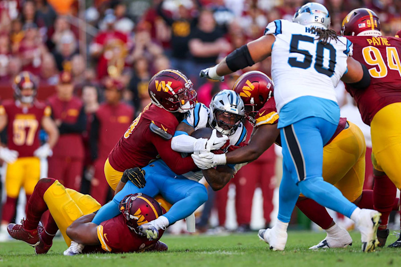 LANDOVER, MARYLAND - OCTOBER 20: Miles Sanders #6 of the Carolina Panthers is stopped by the Washington Commanders during the second quarter at FedExField on October 20, 2024 in Landover, Maryland. (Photo by Patrick Smith/Getty Images)