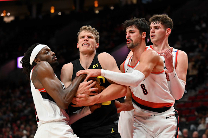 PORTLAND, OREGON - OCTOBER 18: Lauri Markkanen #23 of the Utah Jazz fights for the ball against Jerami Grant #9 and Deni Avdija #8 of the Portland Trail Blazers during the first half of the preseason game at Moda Center on October 18, 2024 in Portland, Oregon. NOTE TO USER: User expressly acknowledges and agrees that, by downloading and or using this photograph, User is consenting to the terms and conditions of the Getty Images License Agreement. (Photo by Alika Jenner/Getty Images)