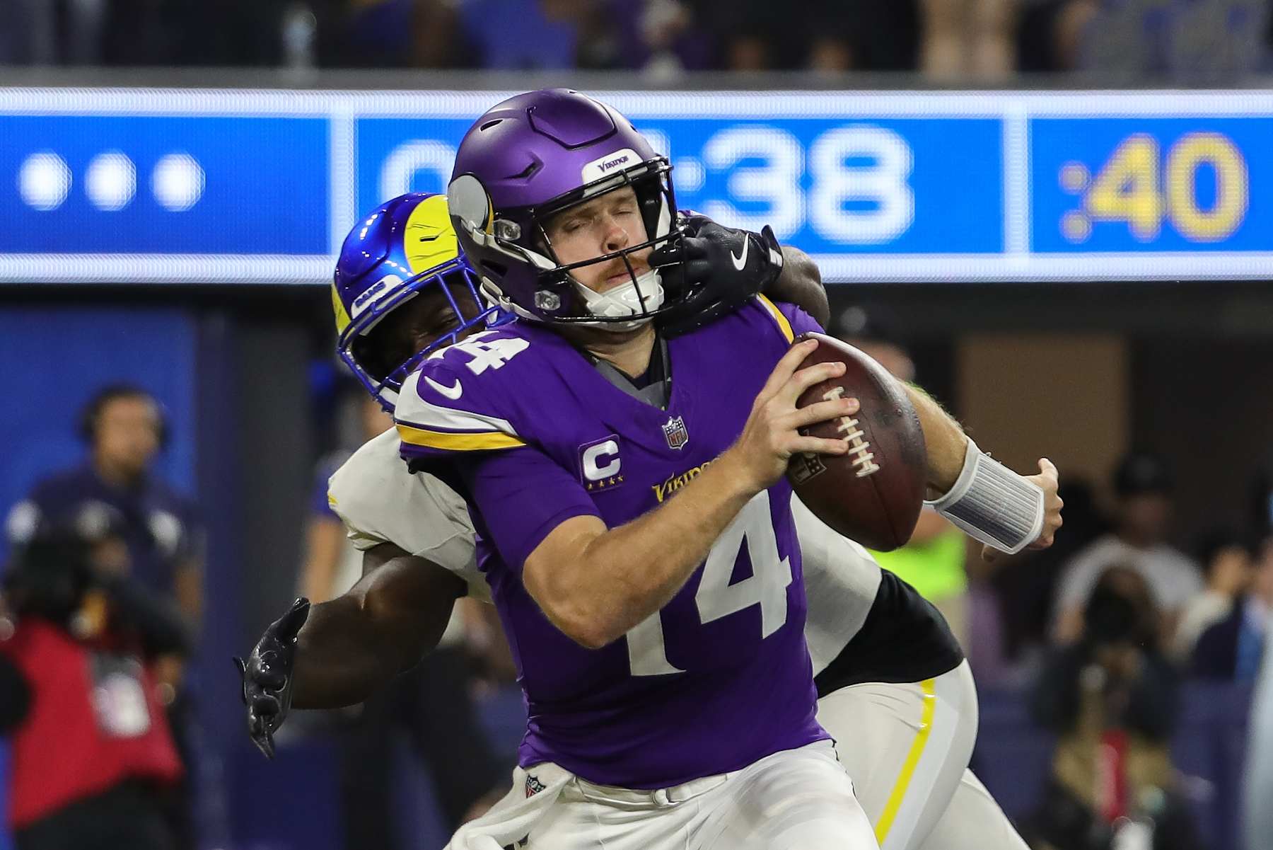 INGLEWOOD, CA - OCTOBER 24: Minnesota Vikings quarterback Sam Darnold (14) gets face masked for a safety by Los Angeles Rams linebacker Byron Young (0) during the NFL game between the Minnesota Vikings and the Los Angeles Rams on October 24, 2024 at SoFi Stadium in Inglewood, CA. (Photo by Jevone Moore/Icon Sportswire via Getty Images)