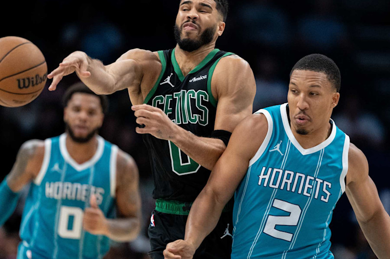 CHARLOTTE, NORTH CAROLINA - NOVEMBER 01: Grant Williams #2 of the Charlotte Hornets fouls Jayson Tatum #0 of the Boston Celtics in the fourth quarter during their game at Spectrum Center on November 01, 2024 in Charlotte, North Carolina. NOTE TO USER: User expressly acknowledges and agrees that, by downloading and or using this photograph, User is consenting to the terms and conditions of the Getty Images License Agreement. (Photo by Jacob Kupferman/Getty Images)