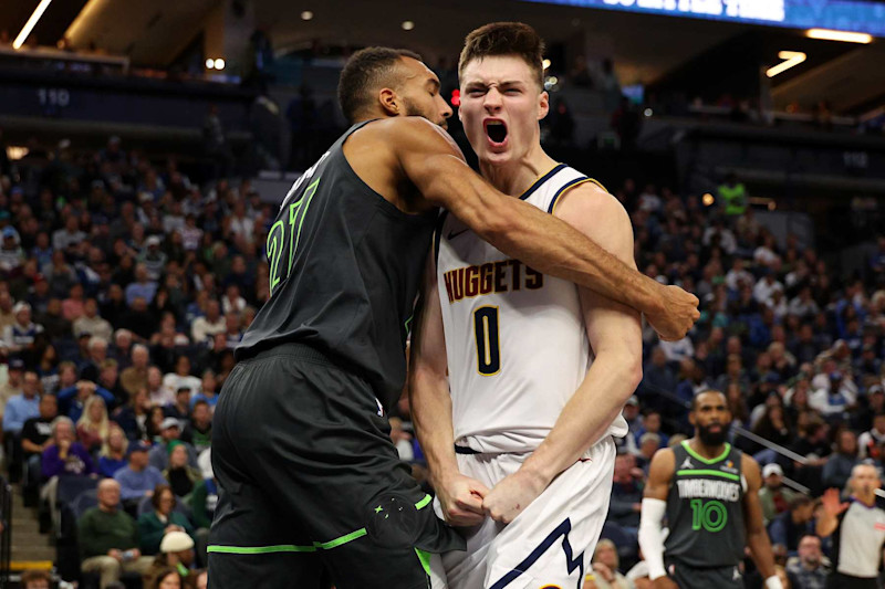 MINNEAPOLIS, MINNESOTA - NOVEMBER 01: Rudy Gobert #27 of the Minnesota Timberwolves and Christian Braun #0 of the Denver Nuggets get into a scrum in the fourth quarter. Gobert and Braun received technical fouls at Target Center on November 01, 2024 in Minneapolis, Minnesota. The Timberwolves defeated the Nuggets 119-116. NOTE TO USER: User expressly acknowledges and agrees that, by downloading and or using this photograph, User is consenting to the terms and conditions of the Getty Images License Agreement. (Photo by David Berding/Getty Images)