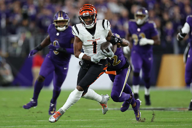 BALTIMORE, MARYLAND - NOVEMBER 07: Ja'Marr Chase #1 of the Cincinnati Bengals is hit after his reception by Marcus Williams #32 of the Baltimore Ravens during the first quarter at M&T Bank Stadium on November 07, 2024 in Baltimore, Maryland. (Photo by Scott Taetsch/Getty Images)