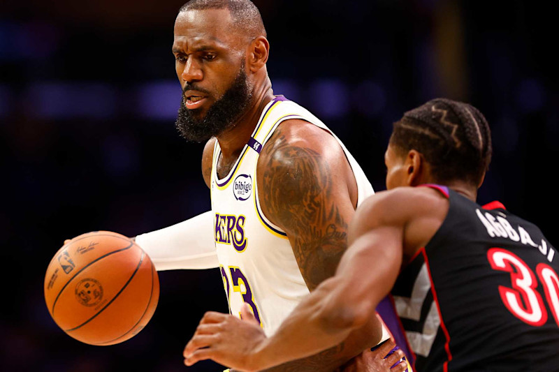 LOS ANGELES, CALIFORNIA - NOVEMBER 10:  LeBron James #23 of the Los Angeles Lakers controls the ball against Ochai Agbaji #30 of the Toronto Raptors in the first half at Crypto.com Arena on November 10, 2024 in Los Angeles, California.  NOTE TO USER: User expressly acknowledges and agrees that, by downloading and/or using this photograph, user is consenting to the terms and conditions of the Getty Images License Agreement. (Photo by Ronald Martinez/Getty Images)