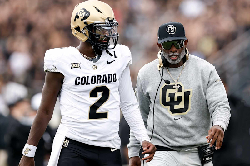 ORLANDO, FL - SEPTEMBER 28: Quarterback Shedeur Sanders #2 talk with Head Coach Deion Sanders of the Colorado Buffaloes prior to the game against the UCF Knights at FBC Mortgage Stadium on September 28, 2024 in Orlando, Florida. The Buffaloes defeated the Knights 48-21.(Photo by Don Juan Moore/Getty Images)