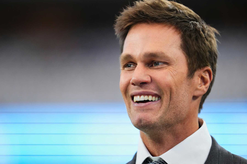 ARLINGTON, TX - OCTOBER 13: NFL broadcast analyst Tom Brady looks on from the sideline before kickoff between the Detroit Lions and the Dallas fCowboys during an NFL football game at AT&T Stadium on October 13, 2024 in Arlington, Texas. (Photo by Cooper Neill/Getty Images)