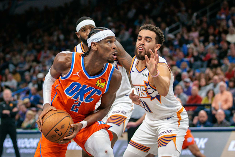 OKLAHOMA CITY, OKLAHOMA - NOVEMBER 15: Shai Gilgeous-Alexander #2 of the Oklahoma City Thunder drives around Tyus Jones #21 of the Phoenix Suns during the third quarter of the Emirates NBA Cup game at Paycom Center on November 15, 2024 in Oklahoma City, Oklahoma. NOTE TO USER: User expressly acknowledges and agrees that, by downloading and or using this photograph, User is consenting to the terms and conditions of the Getty Images License Agreement. (Photo by William Purnell/Getty Images)