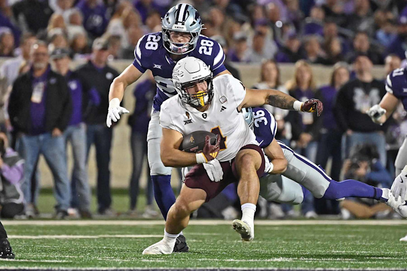 MANHATTAN, KS - NOVEMBER 16:  Running back Cam Skattebo #4 of the Arizona State Sun Devils runs up field past linebacker Rex Van Wyhe #28 of the Kansas State Wildcats in the first half at Bill Snyder Family Football Stadium on November 16, 2024 in Manhattan, Kansas. (Photo by Peter Aiken/Getty Images)