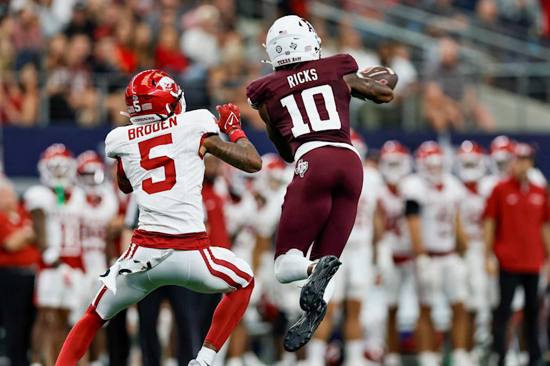 ARLINGTON, TX - SEPTEMBER 28: Texas A&M Aggies defensive back Dezz Ricks (10) steps in front of Arkansas Razorbacks wide receiver Tyrone Broden (5) for an interception during the Southwest Classic game between the Arkansas Razorbacks and the Texas A&M Aggies on September 28, 2024 at AT&T Stadium in Arlington, Texas. (Photo by Matthew Pearce/Icon Sportswire via Getty Images)