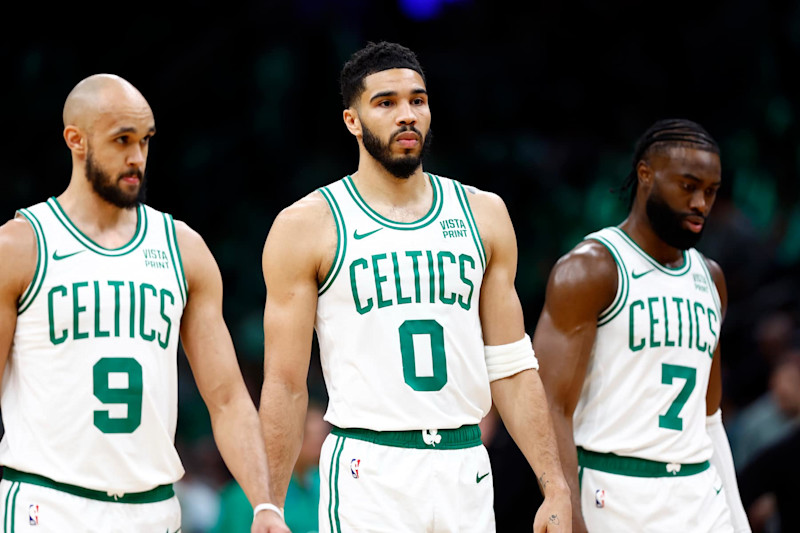 Boston, MA - May 7: Boston Celtics guard Derrick White, forward Jayson Tatum and guard Jaylen Brown walk onto the court during the first quarter. (Photo by Danielle Parhizkaran/The Boston Globe via Getty Images)