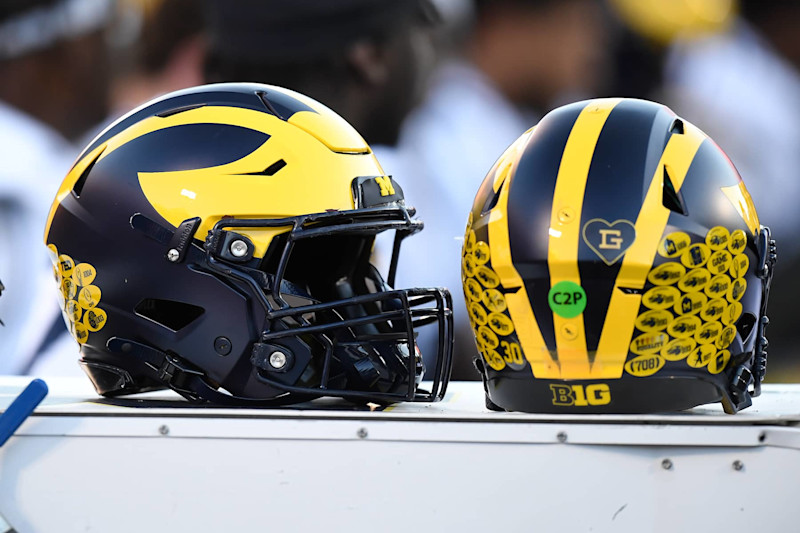 CHAMPAIGN, IL - OCTOBER 19: Two Michigan Wolverines helmets sit on the team bench during the college football game between the Michigan Wolverines and the Illinois Fighting Illini on October 19, 2024, at Memorial Stadium, in Champaign, Illinois. (Photo by Michael Allio/Icon Sportswire via Getty Images)