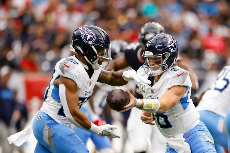 HOUSTON, TEXAS - NOVEMBER 24: Will Levis #8 hands off the ball to Tony Pollard #20 of the Tennessee Titans during the first quarter against the Houston Texans at NRG Stadium on November 24, 2024 in Houston, Texas. (Photo by Tim Warner/Getty Images)