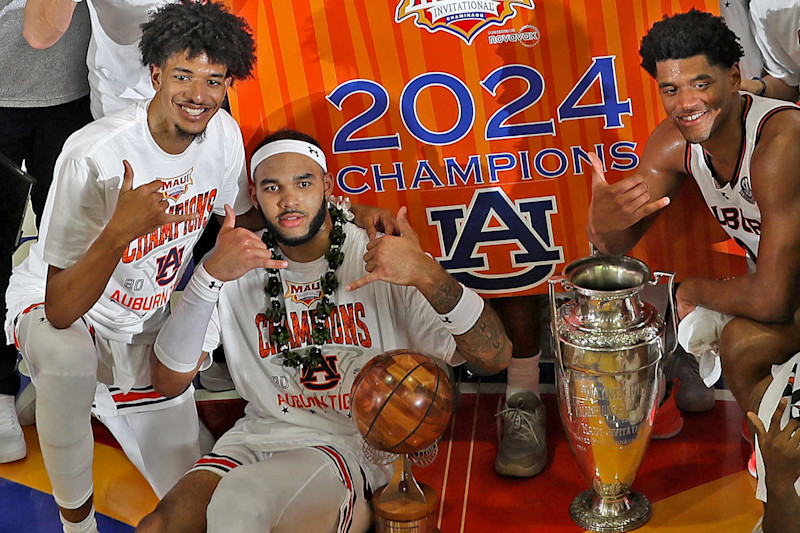 MAUI, HI - NOVEMBER 27: Auburn Tigers forward Johni Broome (4 ) poses with the MVP Trophy and the Wayne Duke Trophy after defeating the Memphis Tigers in the championship game of the Maui Invitational on November 27, 2024, at the Lahaina Civic Center in Maui, Hawaii. (Photo by Brian Spurlock/Icon Sportswire via Getty Images)