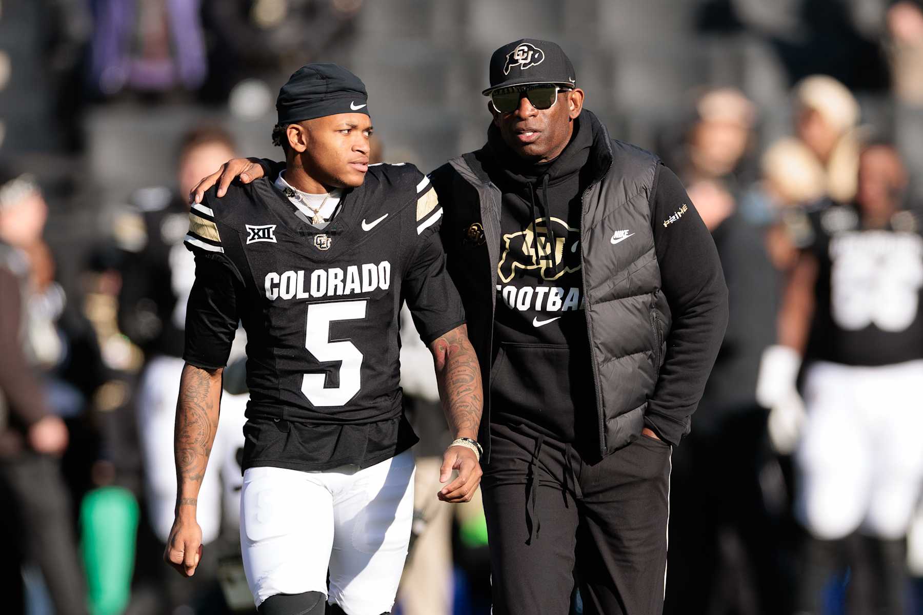 BOULDER, COLORADO - NOVEMBER 29: Jimmy Horn Jr. #5 and Head coach Deion Sanders of the Colorado Buffaloes walk the field during a senior day celebration prior to the game against the Oklahoma State Cowboys at Folsom Field on November 29, 2024 in Boulder, Colorado. (Photo by Andrew Wevers/Getty Images)