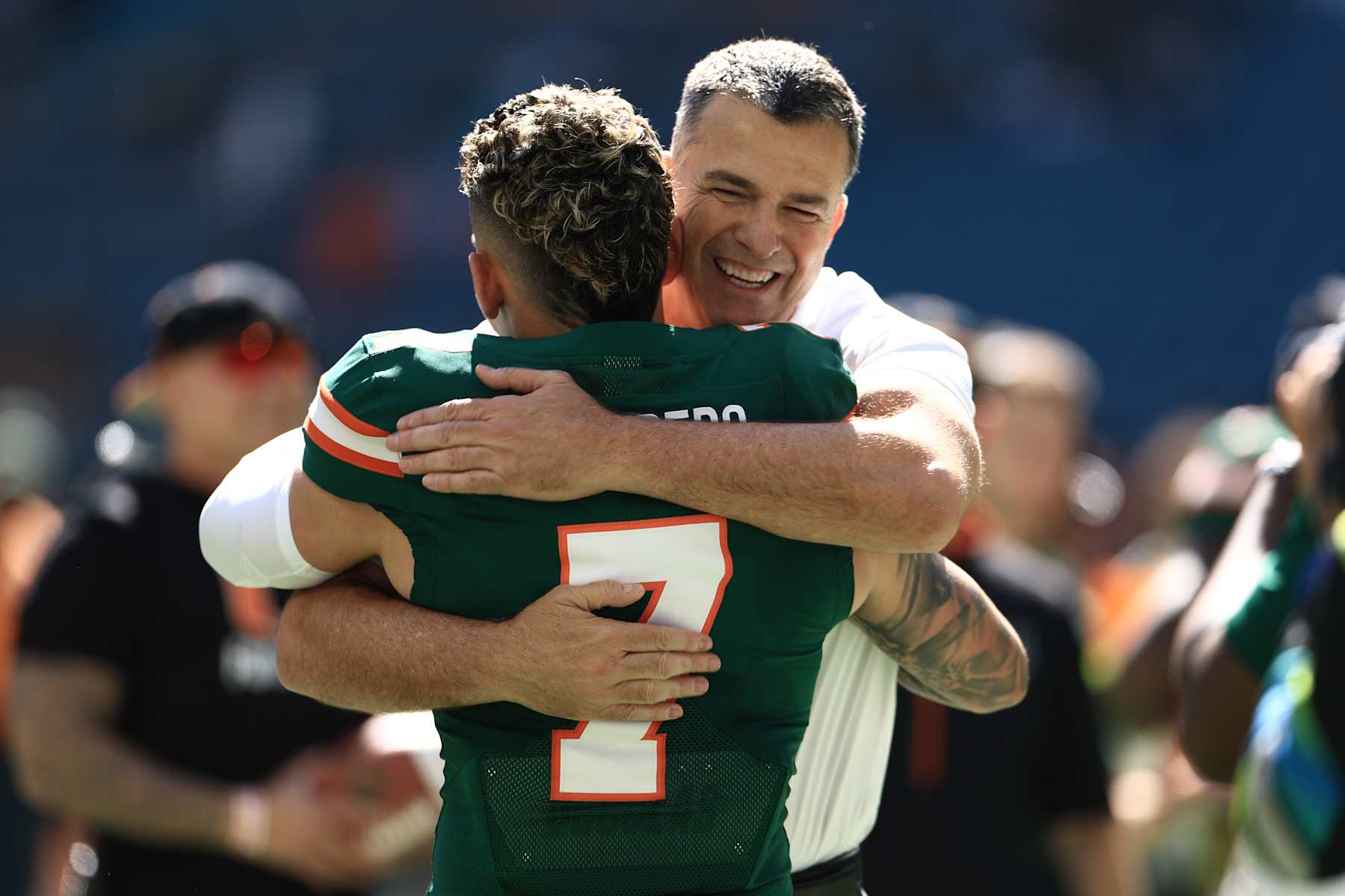 MIAMI GARDENS, FLORIDA - NOVEMBER 23: Mario Cristobal
hugs wide receiver Xavier Restrepo #7 of the Miami Hurricanes ahead of faceing Wake Forest Demon Deacons at Hard Rock Stadium on November 23, 2024 in Miami Gardens, Florida. (Photo by Carmen Mandato/Getty Images)