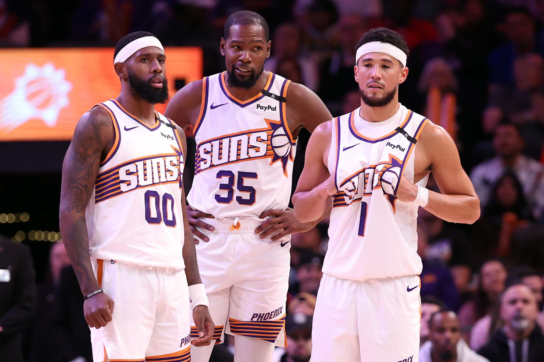 PHOENIX, ARIZONA - NOVEMBER 04: (L-R) Royce O'Neale #00 of the Phoenix Suns, Kevin Durant #35 and Devin Booker #1 stand on the floor during a timeout in the game /apl at Footprint Center on November 04, 2024 in Phoenix, Arizona. The Suns defeated the 76ers 118-116. NOTE TO USER: User expressly acknowledges and agrees that, by downloading and or using this photograph, User is consenting to the terms and conditions of the Getty Images License Agreement. (Photo by Chris Coduto/Getty Images)