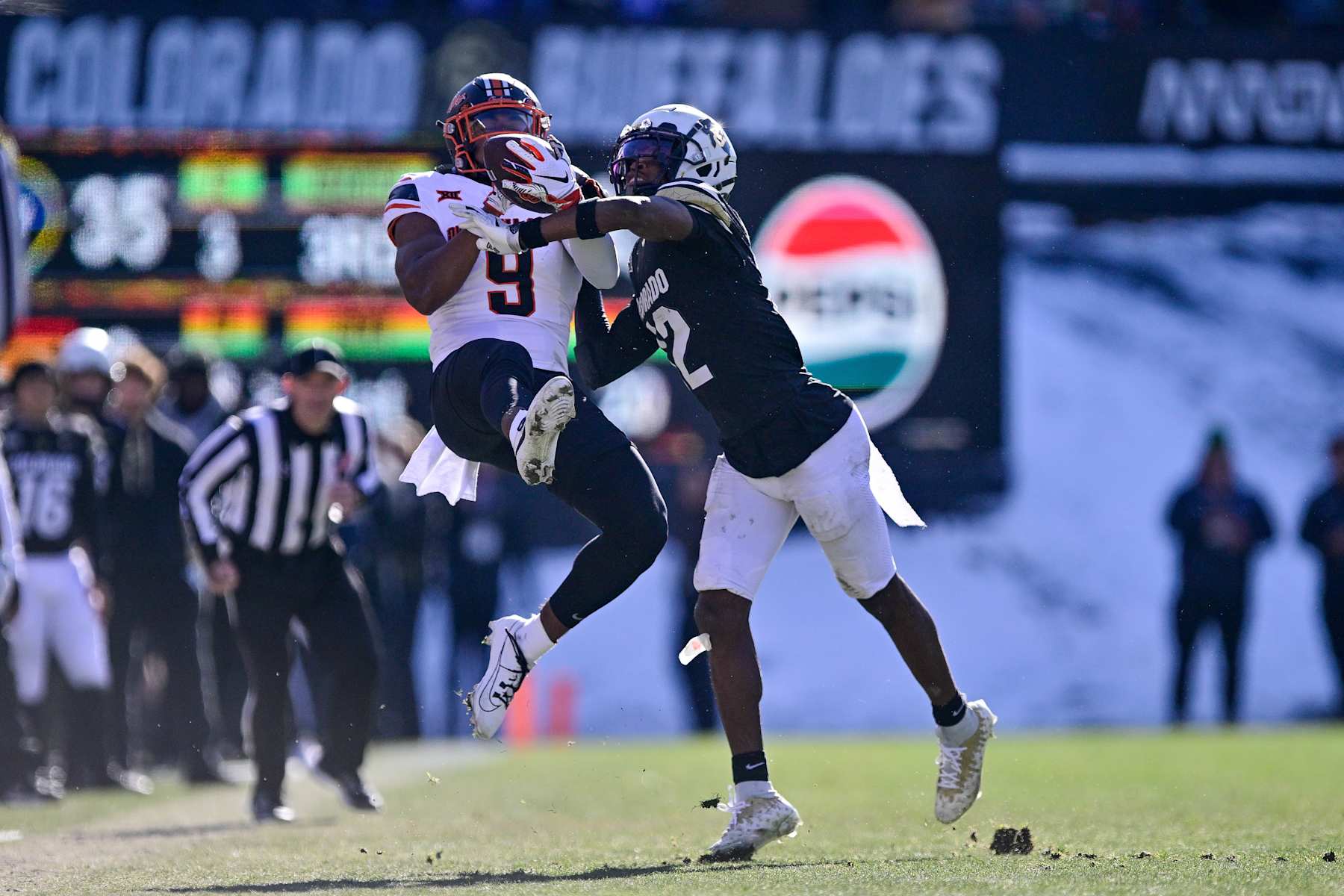 BOULDER, CO - NOVEMBER 29: Travis Hunter #12 of the Colorado Buffaloes defends a pass intended for Ayo Shotomide-King #9 of the Oklahoma State Cowboys in the third quarter at Folsom Field on November 29, 2024 in Boulder, Colorado. (Photo by Dustin Bradford/Getty Images)