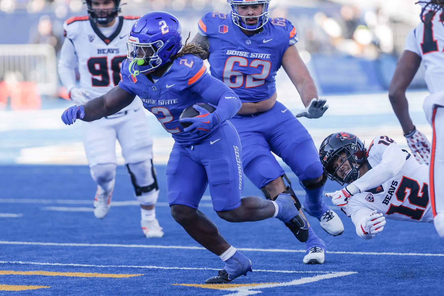 BOISE, ID - NOVEMBER 29: Running back Ashton Jeanty #2 of the Boise State Broncos slips through the tackle attempt of defensive back Tyrice Ivy Jr. #12 of the Oregon State Beavers during the second half t Albertsons Stadium on November 29, 2024 in Boise, Idaho. Boise State won the game 34-18. (Photo by Loren Orr/Getty Images)