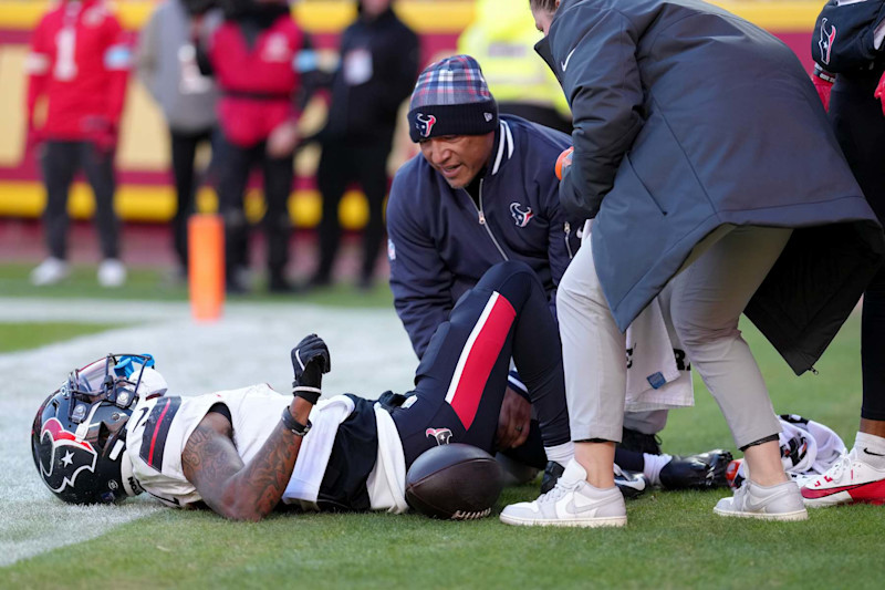 KANSAS CITY, MISSOURI - DECEMBER 21: Medical staff look at Tank Dell #3 of the Houston Texans after Dell sustained an injury while catching a touchdown in the third quarter of a game against the Kansas City Chiefs at GEHA Field at Arrowhead Stadium on December 21, 2024 in Kansas City, Missouri. (Photo by Jason Hanna/Getty Images)