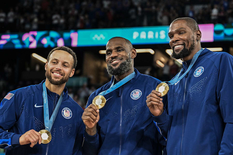 TOPSHOT - Gold medallists (From L) USA's #04 Stephen Curry, USA's #06 LeBron James and USA's #07 Kevin Durant pose after the men's Gold Medal basketball match between France and USA during the Paris 2024 Olympic Games at the Bercy  Arena in Paris on August 10, 2024. (Photo by Damien MEYER / AFP) (Photo by DAMIEN MEYER/AFP via Getty Images)